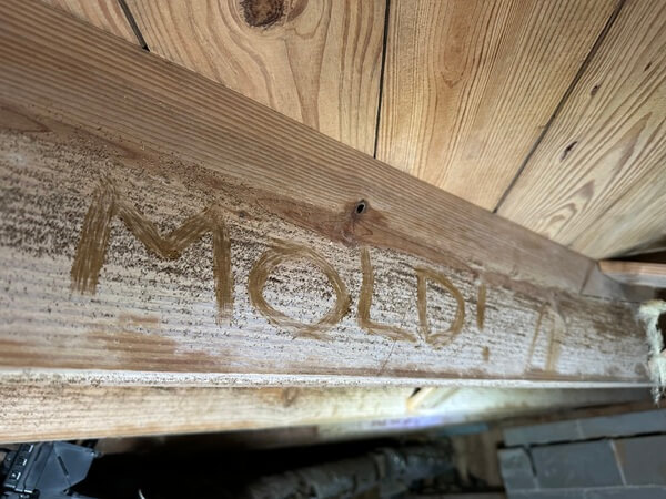 Close-up of wood joists being cleaned by soda blasting during crawl space mold remediation