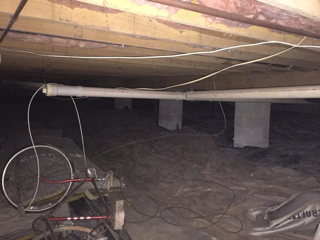 Wet crawl space with a dehumidifier running during the dry-out phase